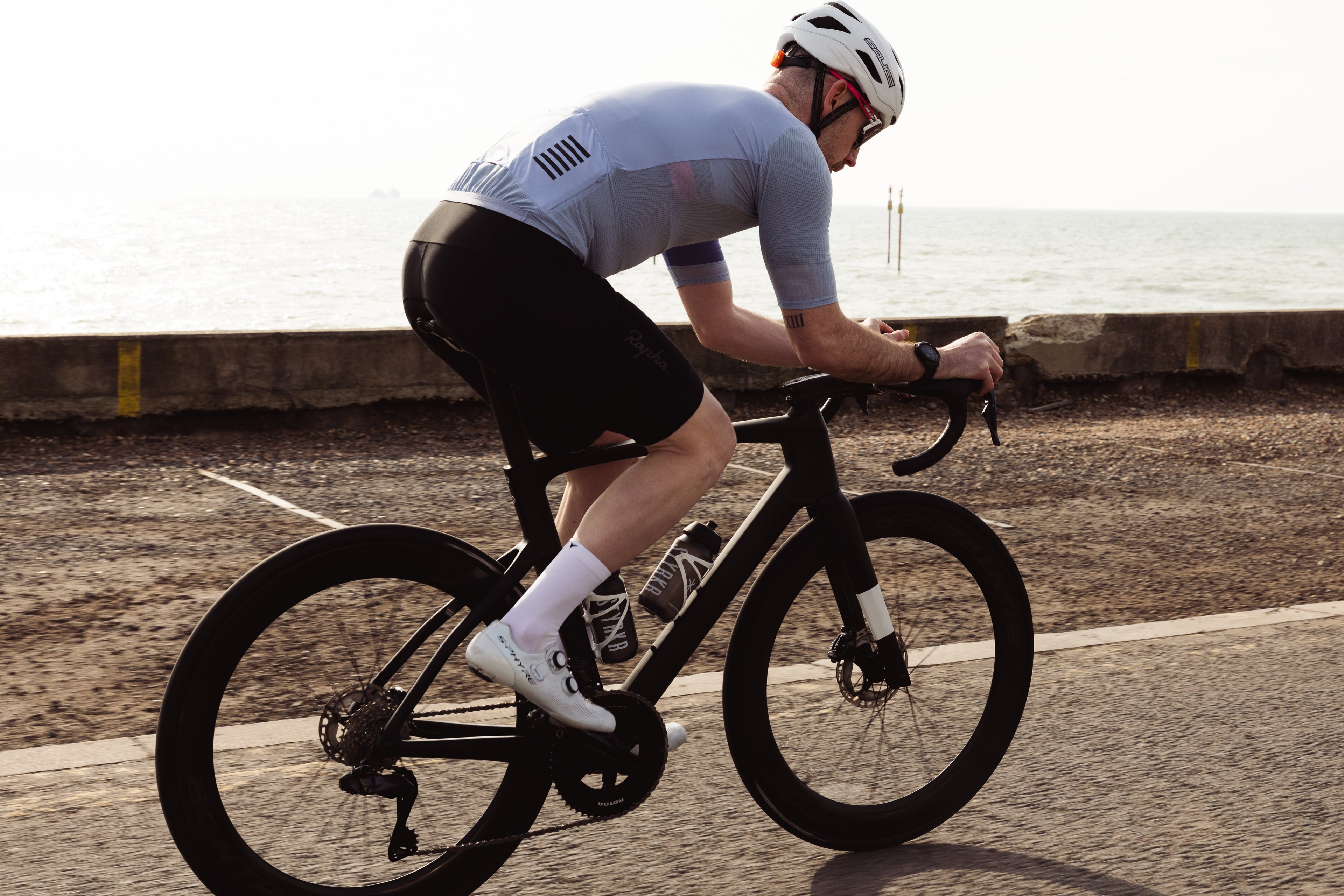 Riding along a beachfront in Veto's white cycling socks