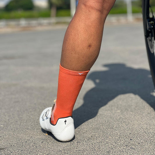 Cyclist stopped whilst wearing orange cycling socks